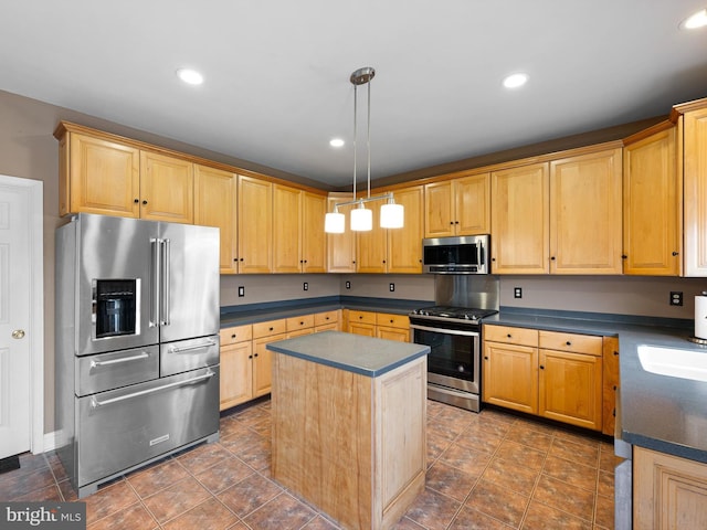 kitchen featuring recessed lighting, appliances with stainless steel finishes, a center island, dark countertops, and decorative light fixtures