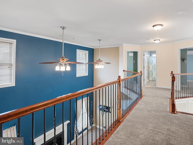 corridor featuring baseboards, light colored carpet, crown molding, and an upstairs landing