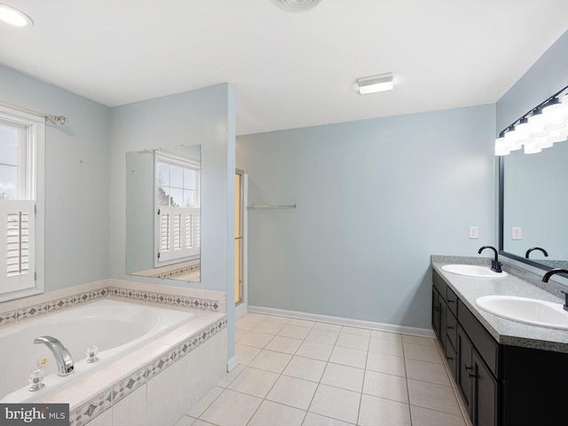 full bath featuring double vanity, a garden tub, a sink, and tile patterned floors