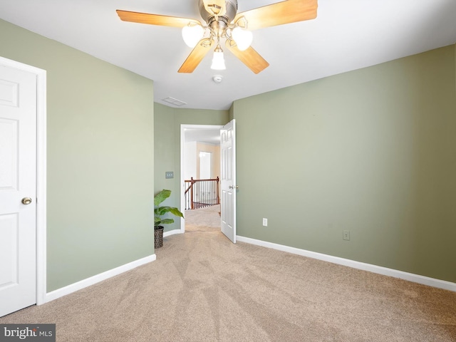 unfurnished bedroom with visible vents, baseboards, ceiling fan, and light colored carpet