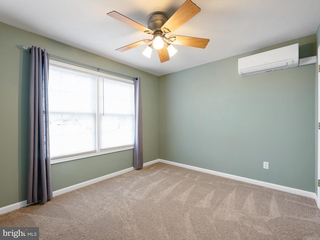 carpeted empty room featuring a ceiling fan, baseboards, and a wall mounted AC