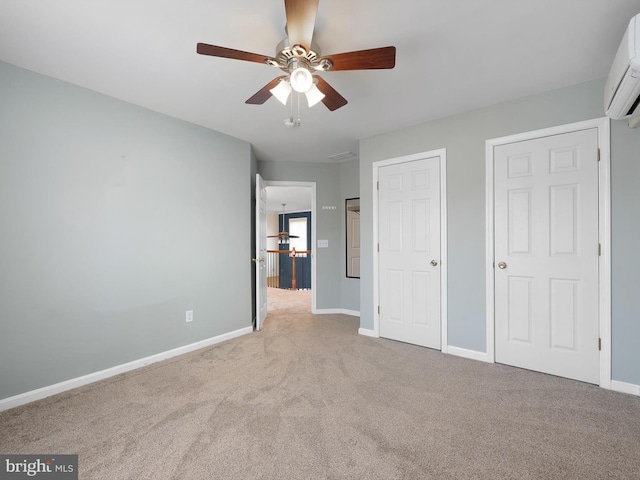 unfurnished bedroom featuring baseboards, an AC wall unit, a ceiling fan, and light colored carpet