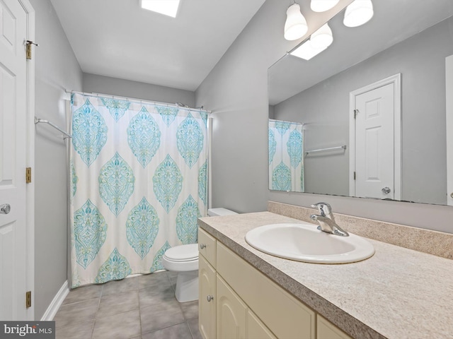 bathroom with toilet, curtained shower, vanity, and tile patterned floors