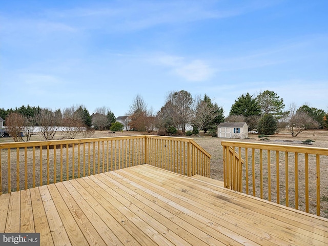 wooden terrace with a storage unit and an outdoor structure