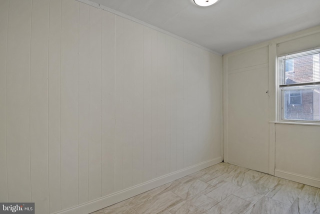 spare room featuring wooden walls