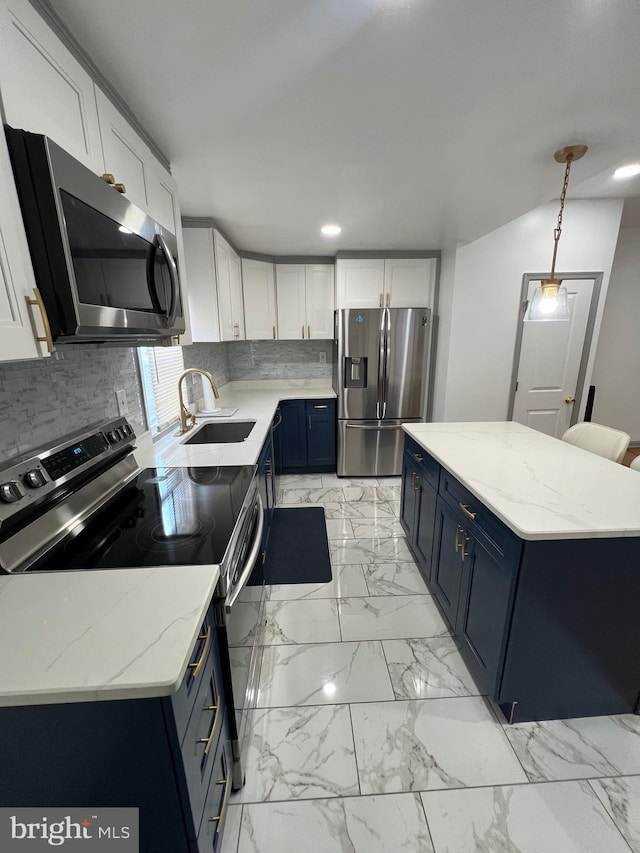 kitchen with decorative light fixtures, blue cabinetry, white cabinets, and appliances with stainless steel finishes