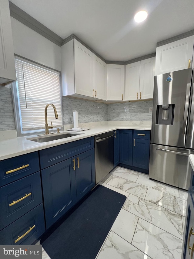 kitchen featuring white cabinetry, stainless steel fridge, blue cabinetry, and dishwasher