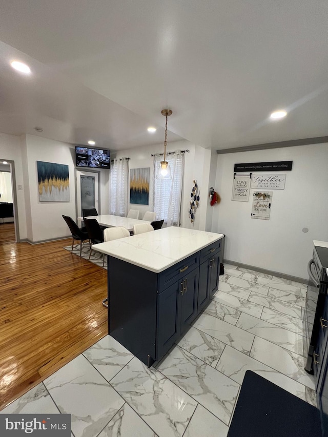 kitchen featuring pendant lighting, a kitchen breakfast bar, and a center island