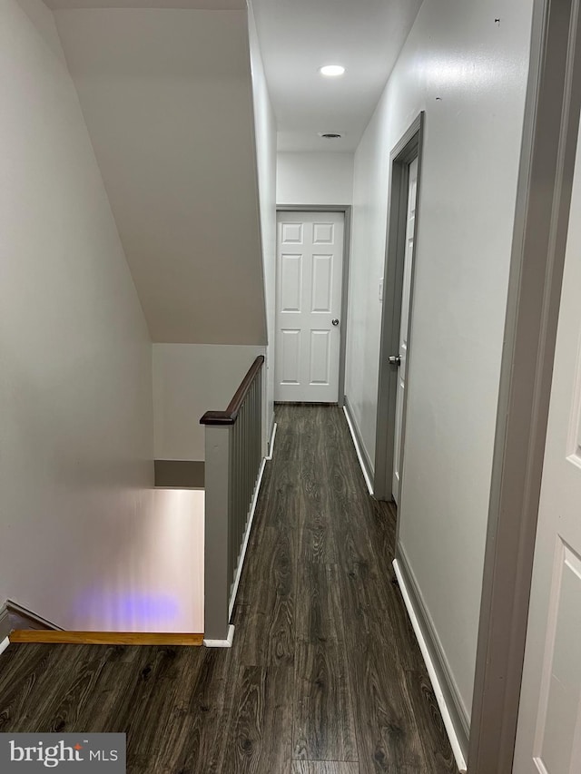 hallway with dark hardwood / wood-style flooring