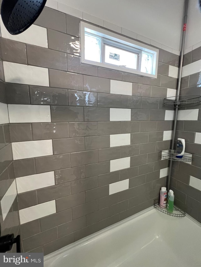 bathroom with a tile shower