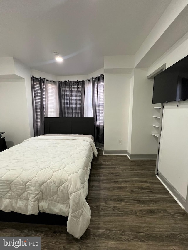 bedroom featuring dark wood-type flooring