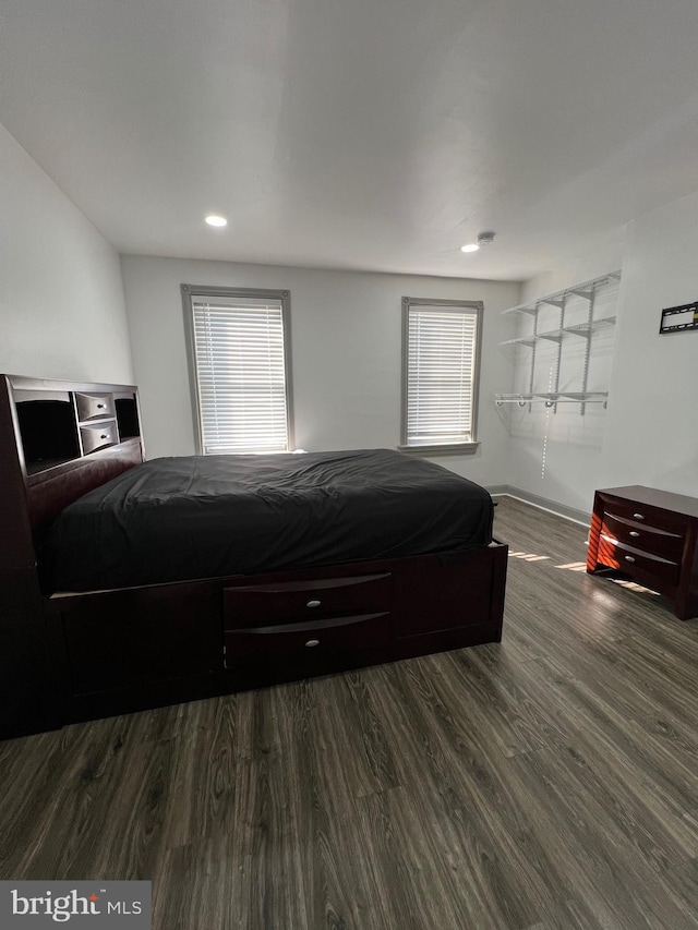 bedroom with dark wood-type flooring