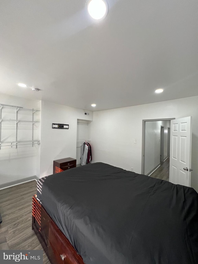 bedroom with dark hardwood / wood-style floors