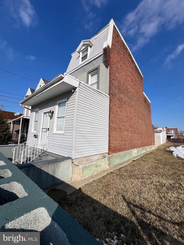 view of side of home featuring a yard