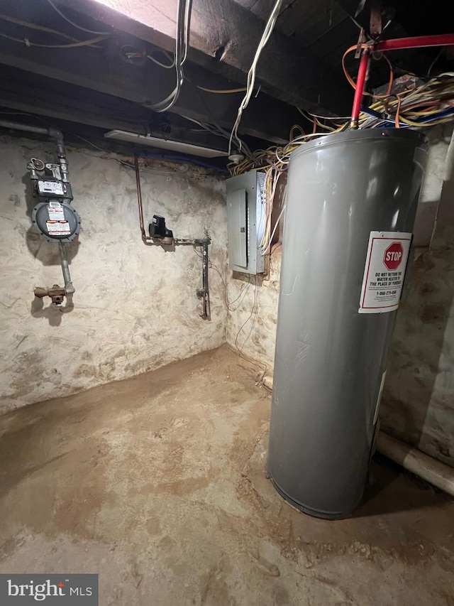 basement featuring water heater and electric panel