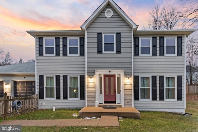 view of front facade featuring a garage and a lawn