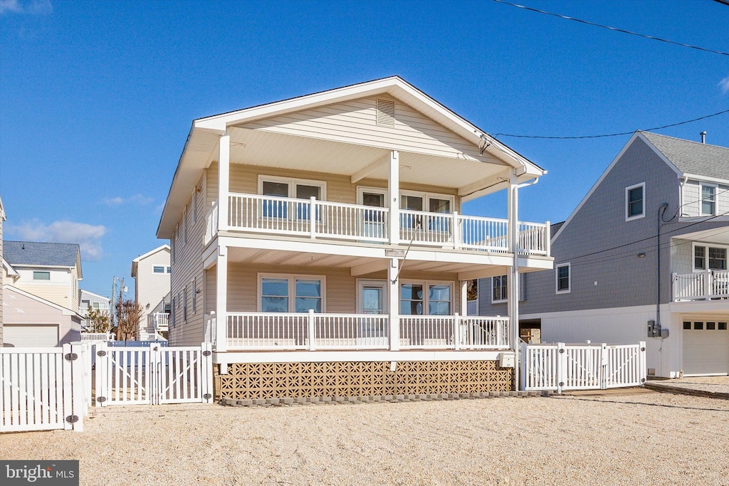 view of front of property featuring a porch and a balcony