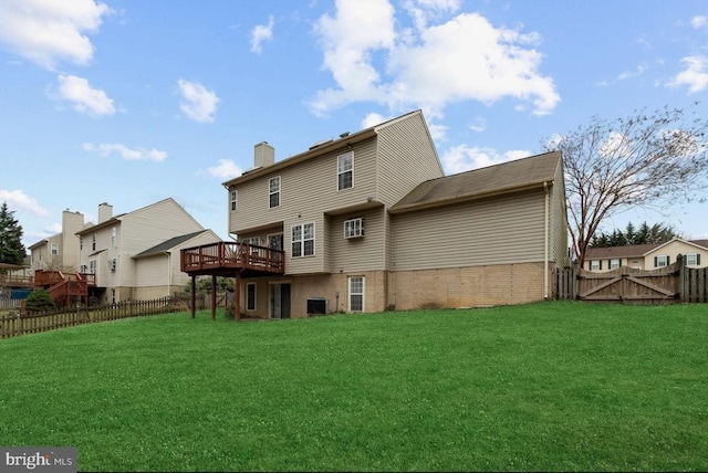 back of house with a wooden deck and a yard