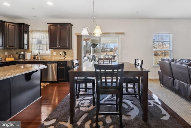 dining room with dark hardwood / wood-style floors and sink