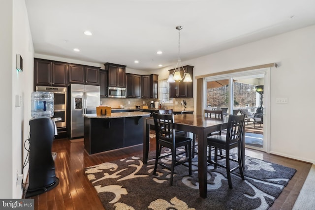 dining area with dark hardwood / wood-style flooring