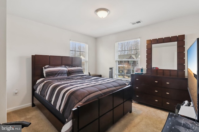 bedroom featuring light carpet and multiple windows