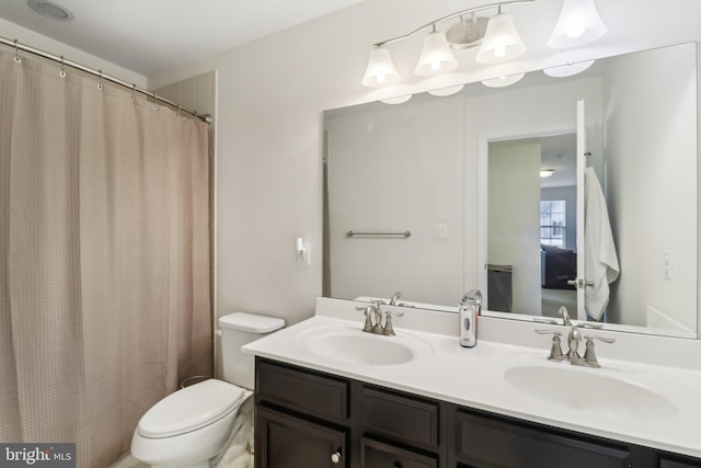 bathroom featuring vanity, toilet, and a shower with shower curtain