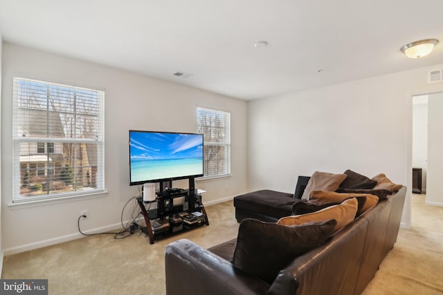 living room with light carpet and a wealth of natural light