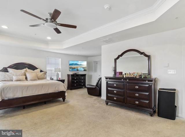 bedroom featuring crown molding, light colored carpet, a raised ceiling, and ceiling fan