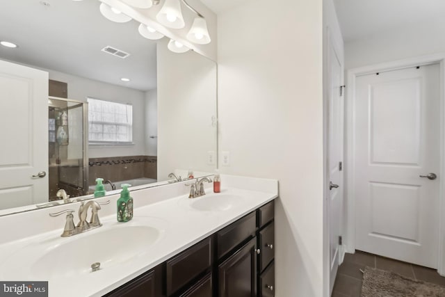 bathroom with tile patterned floors, shower with separate bathtub, and vanity