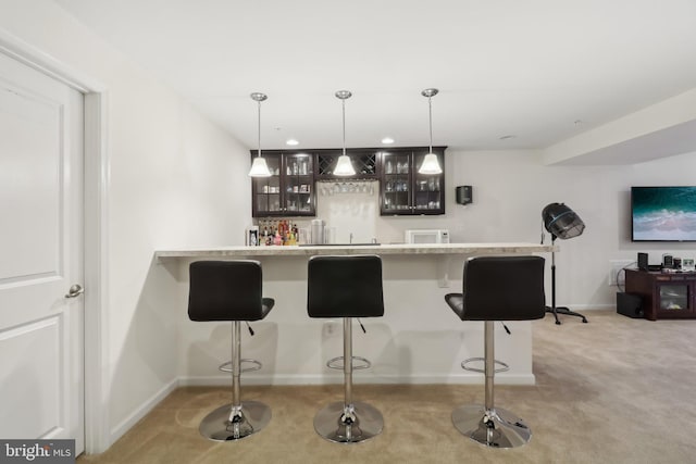 bar featuring pendant lighting and light colored carpet