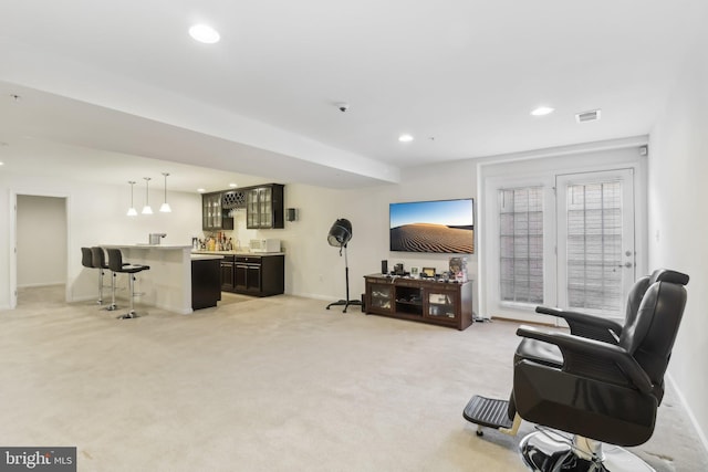 living room with bar and light carpet