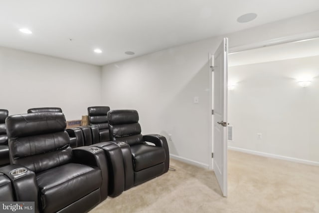 cinema room featuring light carpet