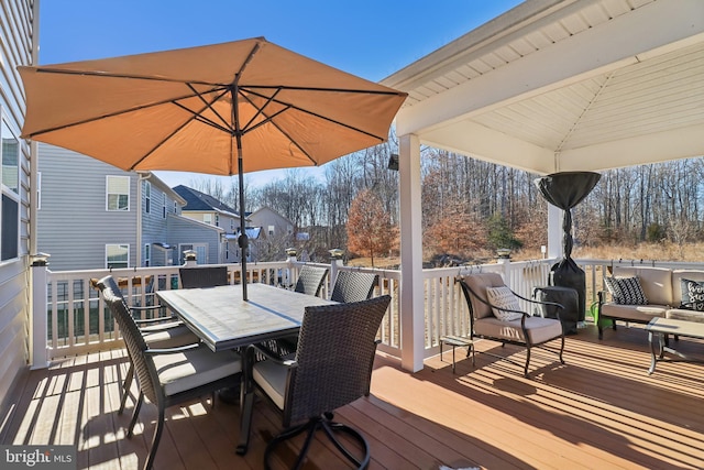 wooden terrace with an outdoor hangout area