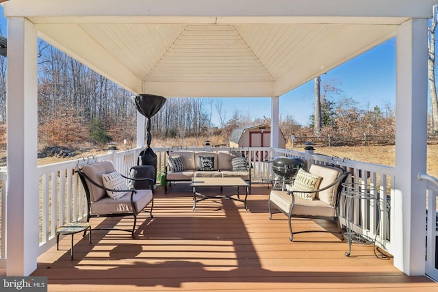 deck featuring a storage shed, a gazebo, and outdoor lounge area