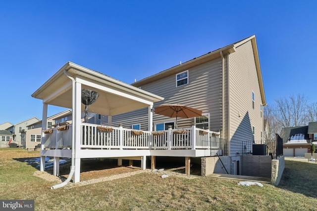 rear view of property with a lawn and a deck