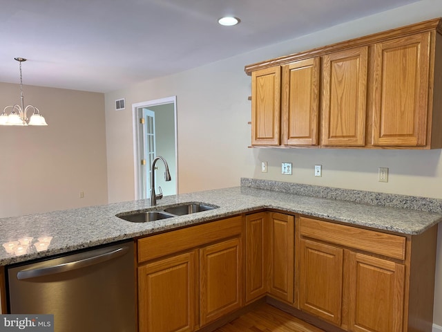 kitchen with light stone counters, dishwasher, sink, and kitchen peninsula