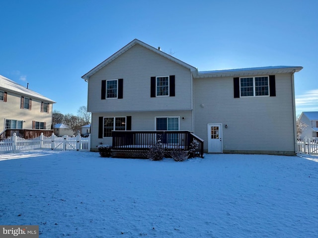 snow covered rear of property with central air condition unit and a deck