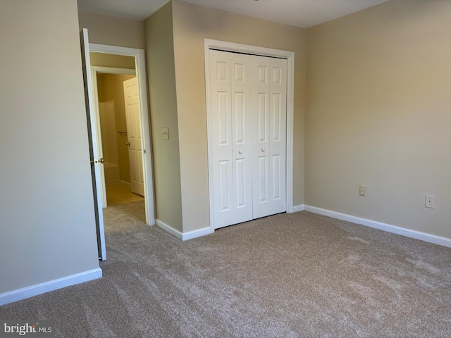 unfurnished bedroom with a closet and carpet