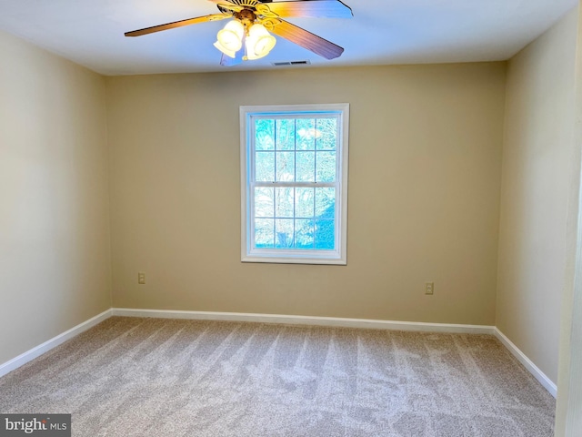 carpeted spare room with ceiling fan