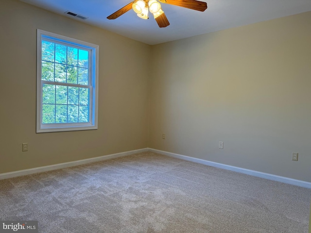 carpeted spare room with ceiling fan