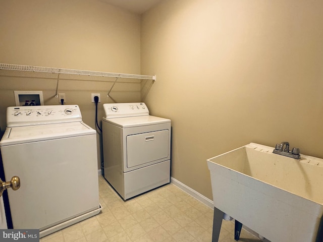 washroom featuring sink and washer and clothes dryer