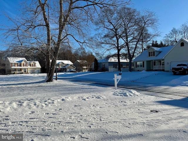 snowy yard with a garage