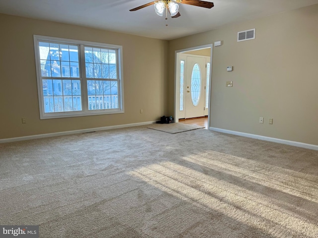 carpeted entrance foyer with ceiling fan