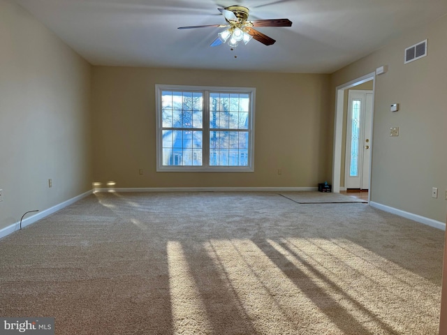 spare room featuring ceiling fan and carpet flooring