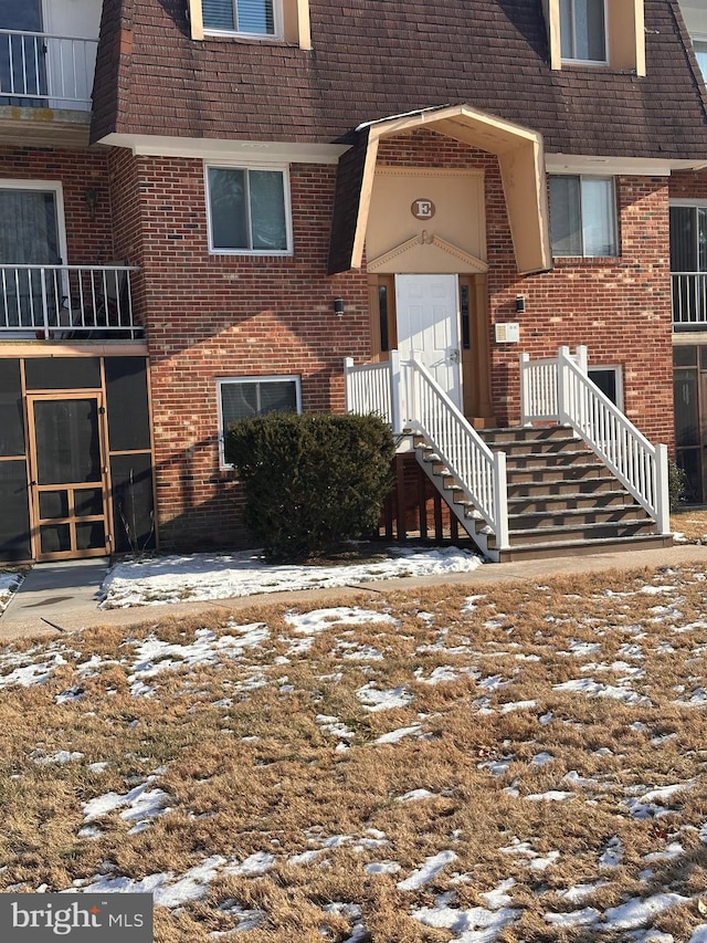 view of snow covered property entrance