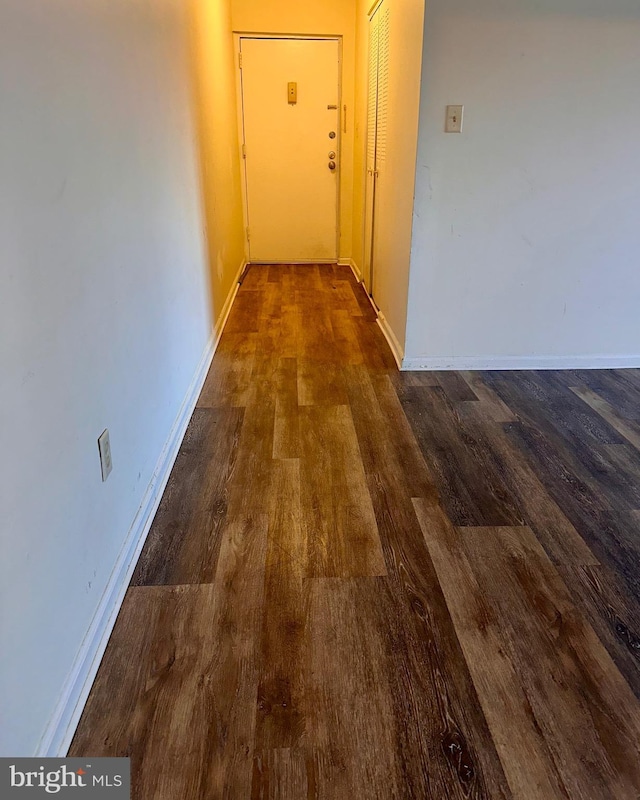 hall with dark wood-type flooring