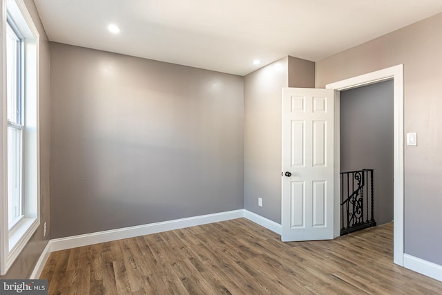 unfurnished room with hardwood / wood-style floors