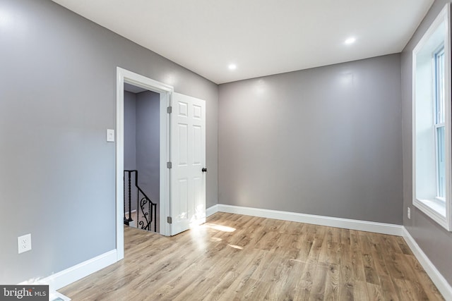 spare room with plenty of natural light and light hardwood / wood-style floors