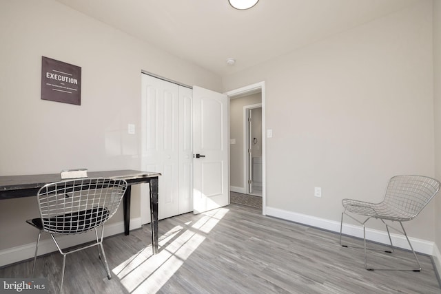 home office with light hardwood / wood-style floors