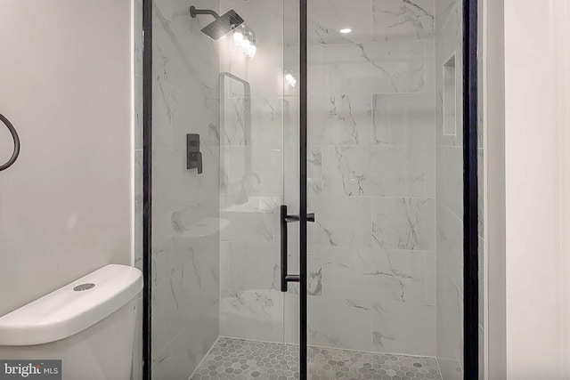 bathroom featuring walk in shower and toilet